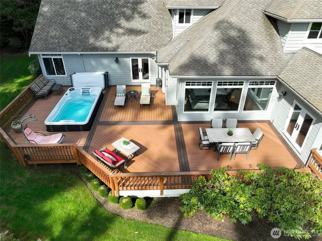an aerial view of a house with swimming pool garden and patio