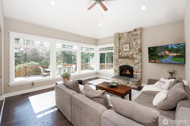 a living room with furniture a flat screen tv and a fireplace