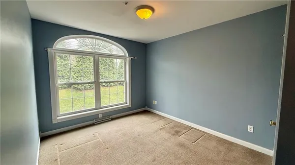 a dining room with furniture and a potted plant