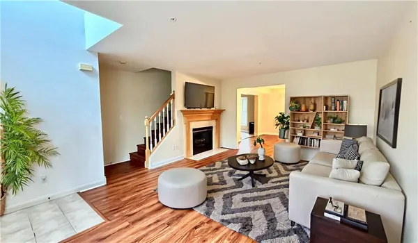 a living room with furniture a fireplace and a potted plant