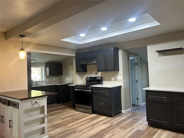 a kitchen with stainless steel appliances granite countertop a sink and stove top oven