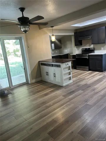 a kitchen with a refrigerator and a stove