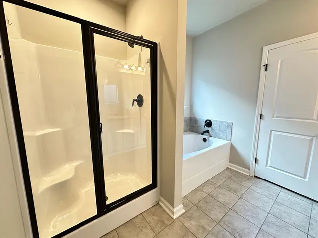 a bathroom with a tub and a shower