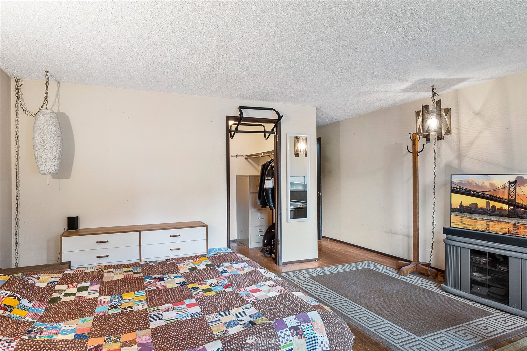 14332 118th Avenue Northeast Kirkland, WA 98034 - Photo 18 of 40 a bedroom with a bed and a flat tv screen on a dresser