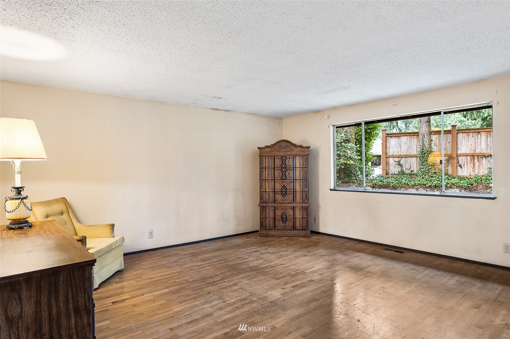 14332 118th Avenue Northeast Kirkland, WA 98034 - Photo 19 of 40 a view of an empty room with a window and wooden floor