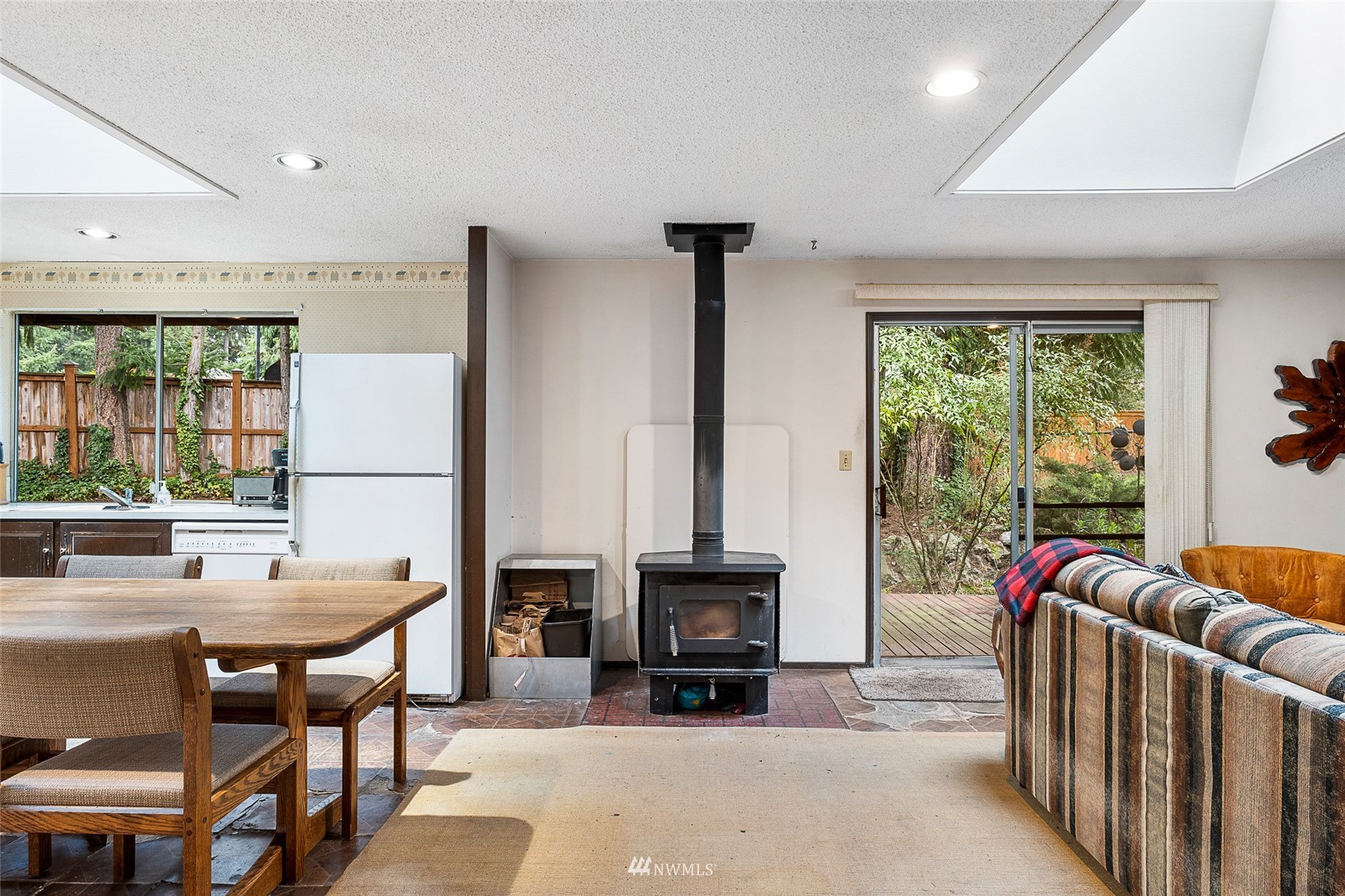 14332 118th Avenue Northeast Kirkland, WA 98034 - Photo 27 of 40 a living room with furniture a fireplace and a large window