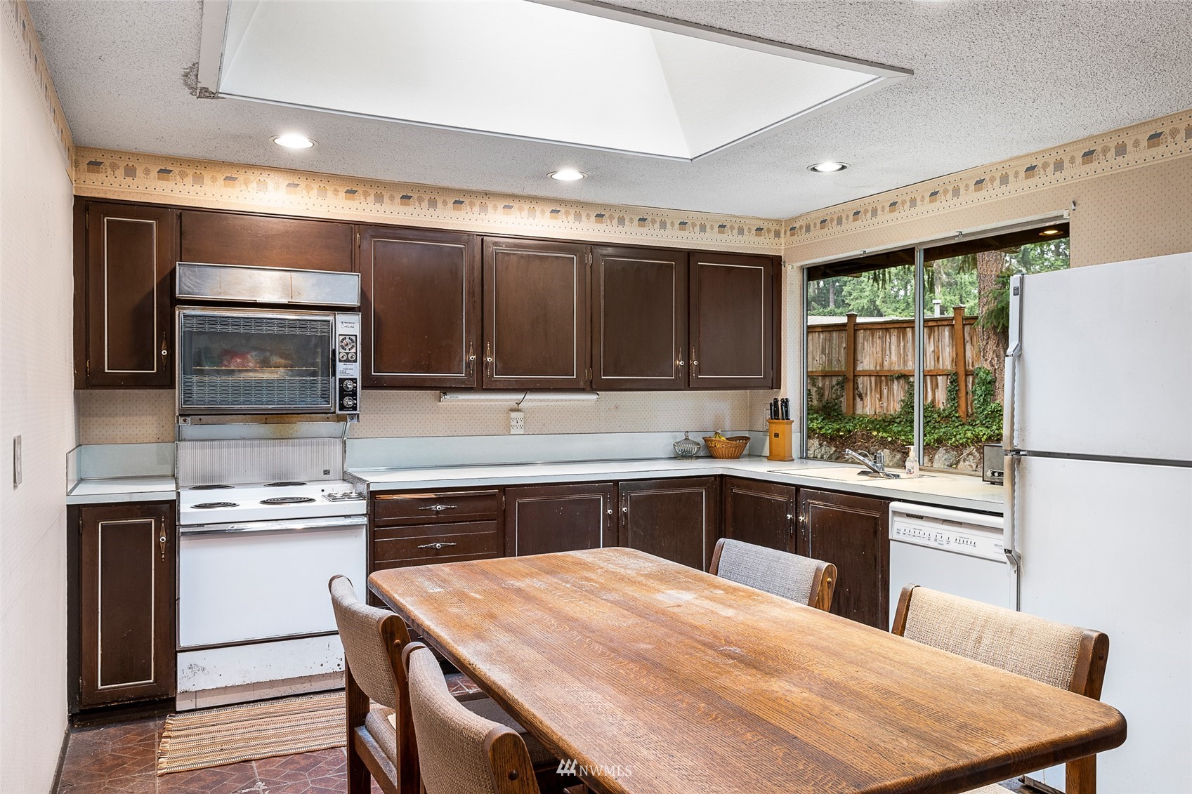 14332 118th Avenue Northeast Kirkland, WA 98034 - Photo 3 of 40 a kitchen with stainless steel appliances granite countertop a stove refrigerator sink and cabinets