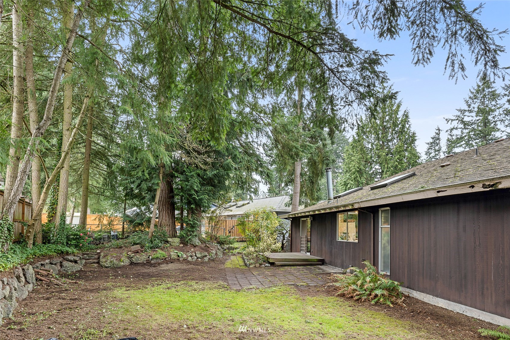 14332 118th Avenue Northeast Kirkland, WA 98034 - Photo 34 of 40 a backyard of a house with table and chairs