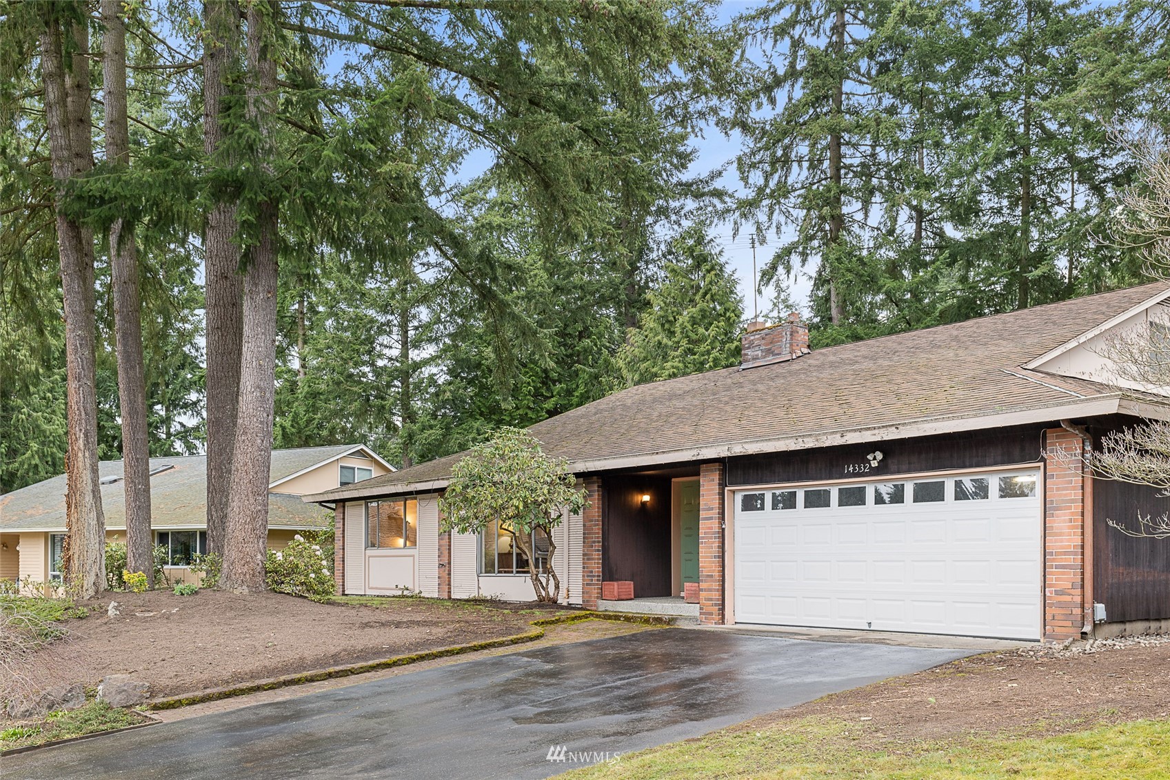 14332 118th Avenue Northeast Kirkland, WA 98034 - Photo 36 of 40 a view of a white house with a large tree