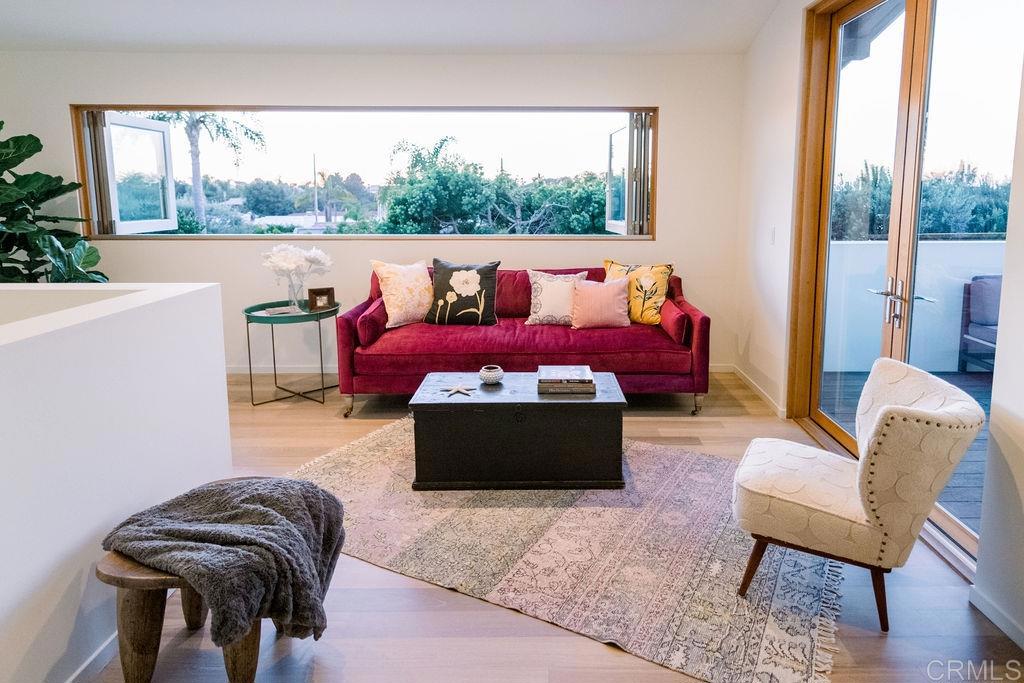1866 Sheridan Road Encinitas, CA 92024 - Photo 16 of 25 a living room with furniture and a floor to ceiling window