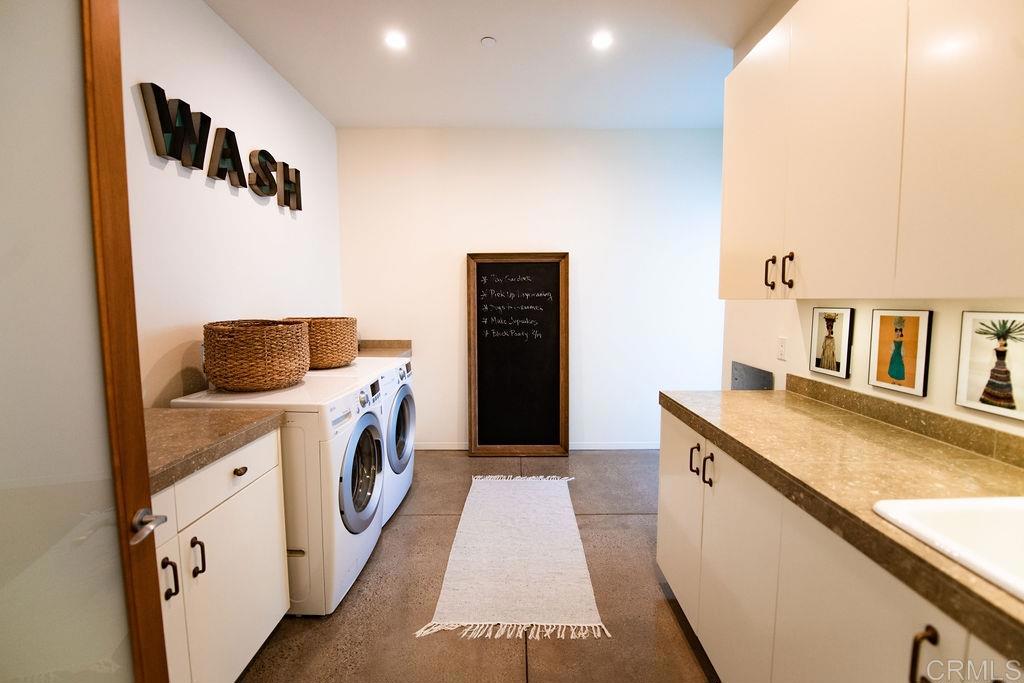 1866 Sheridan Road Encinitas, CA 92024 - Photo 19 of 25 a bathroom with a granite countertop sink and a washer dryer