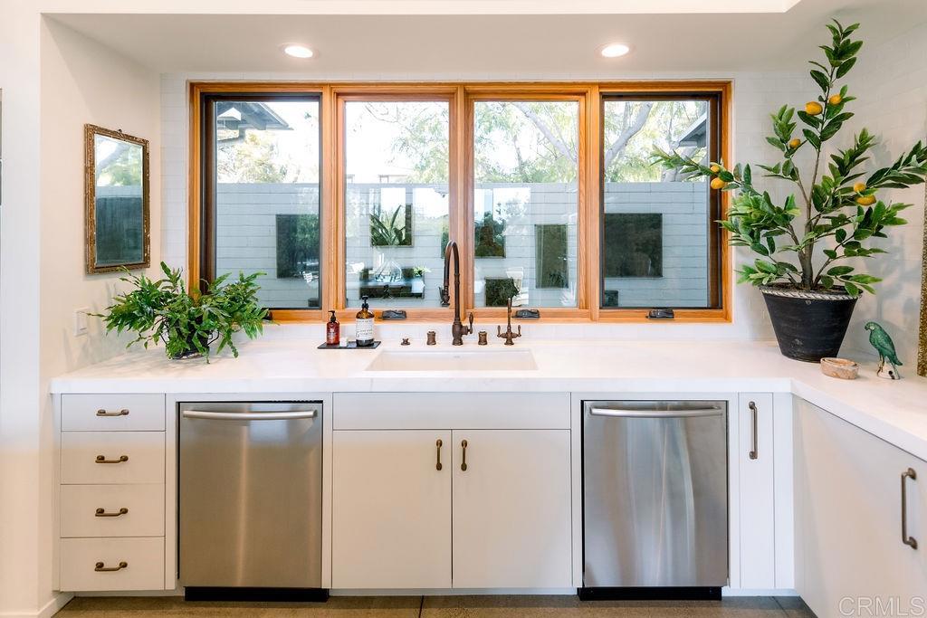 1866 Sheridan Road Encinitas, CA 92024 - Photo 5 of 25 a kitchen with a large window and white cabinets
