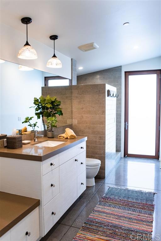 1866 Sheridan Road Encinitas, CA 92024 - Photo 10 of 25 a spacious bathroom with a sink and a mirror