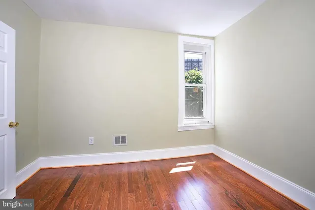 a view of a room with wooden floor and windows