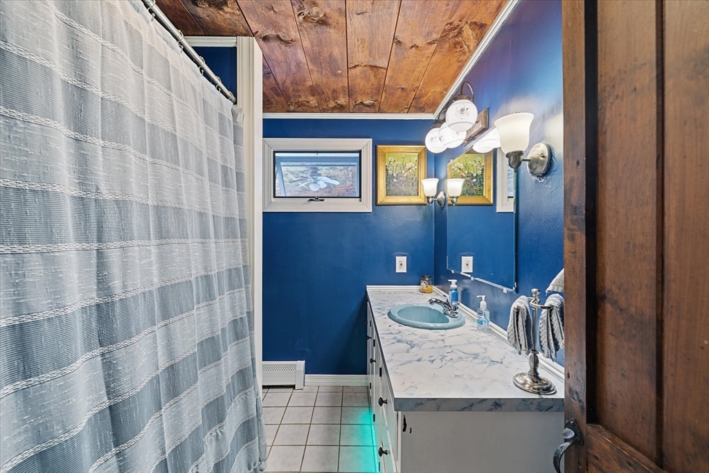 26 Bay Path Road Charlton, MA 01507 - Photo 14 of 38 a bathroom with a sink a mirror and a shower
