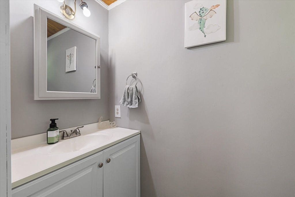26 Bay Path Road Charlton, MA 01507 - Photo 17 of 38 a bathroom with a sink a vanity and mirror