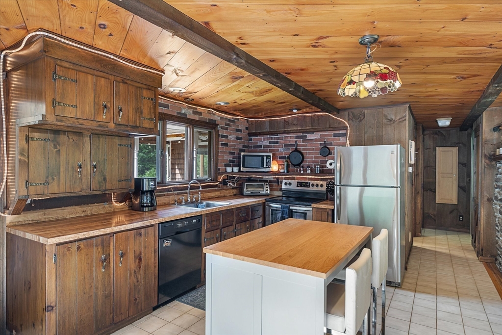 26 Bay Path Road Charlton, MA 01507 - Photo 8 of 38 a kitchen with cabinets and chandelier