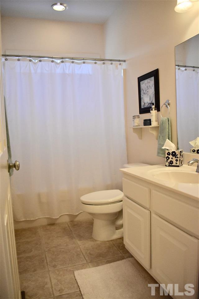 545 Lake Glad Road Wendell, NC 27591 - Photo 16 of 25 First-floor hall bathroom complete with transom window for great natural light.