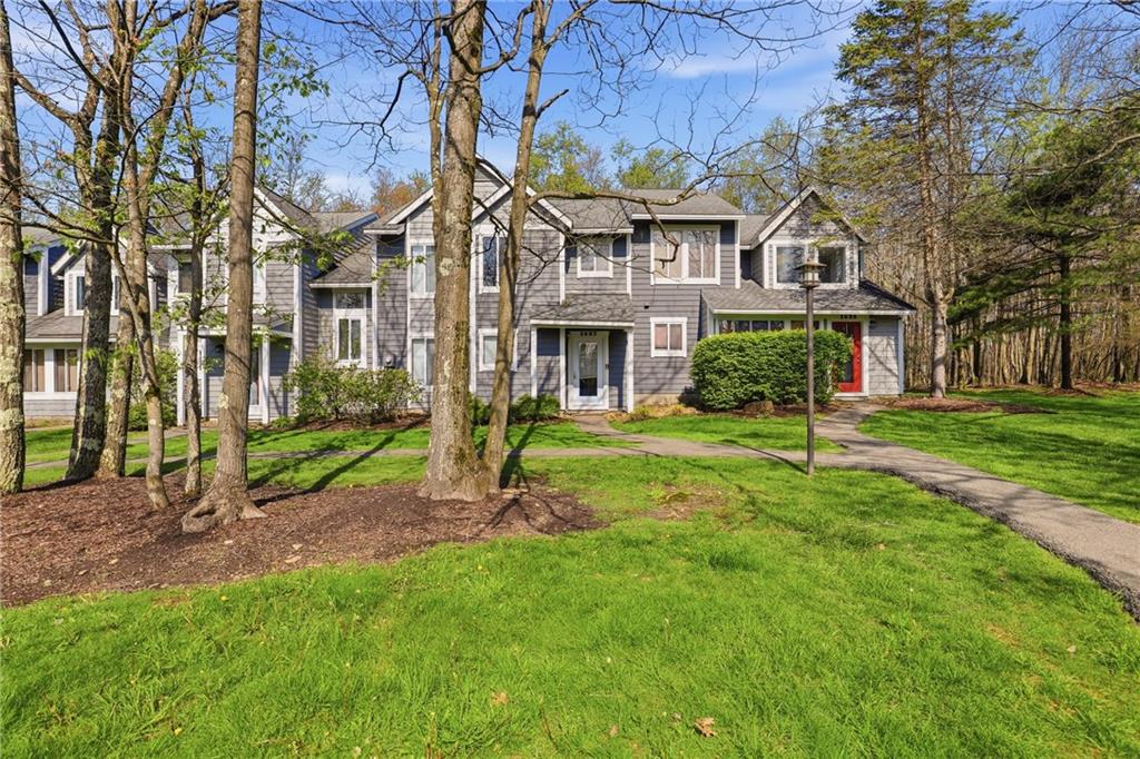 1627 Snowfield Way Hidden Valley, PA 15502 - Photo 1 of 38 a view of a white house next to a yard with big trees