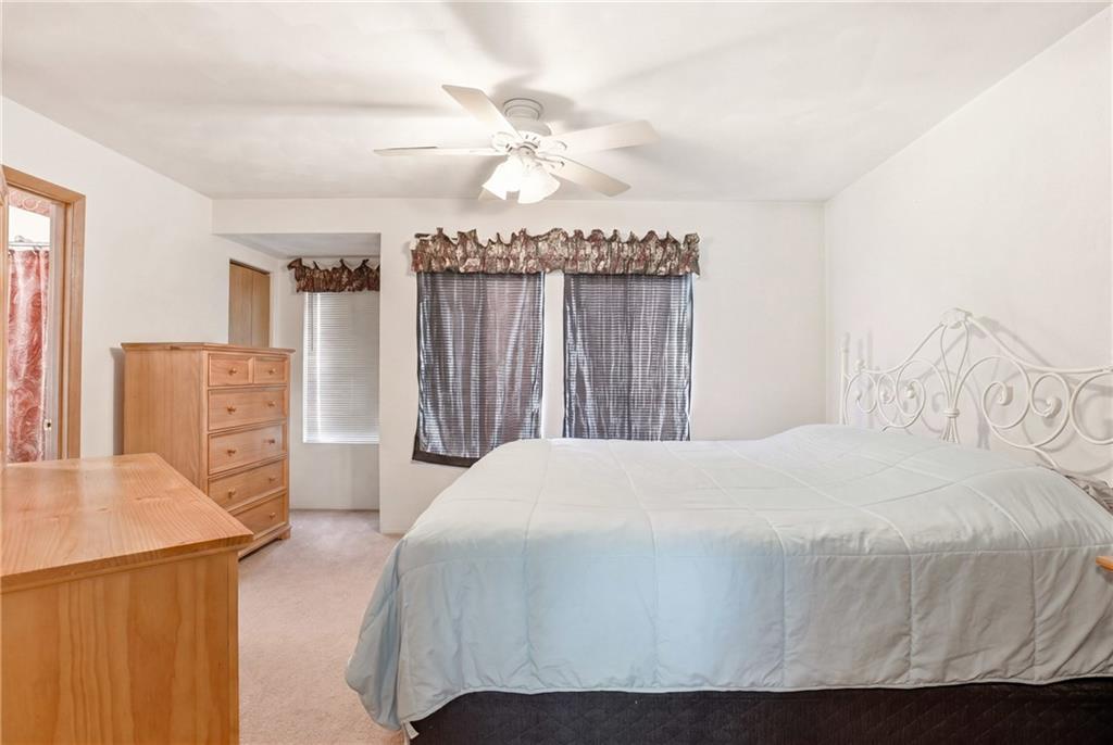 1627 Snowfield Way Hidden Valley, PA 15502 - Photo 17 of 38 a bedroom with a bed a dresser and potted plants