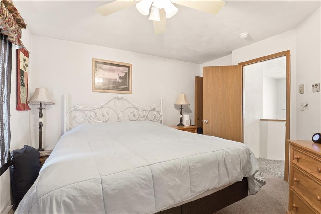 1627 Snowfield Way Hidden Valley, PA 15502 - Photo 18 of 38 a bedroom with a bed and a chandelier