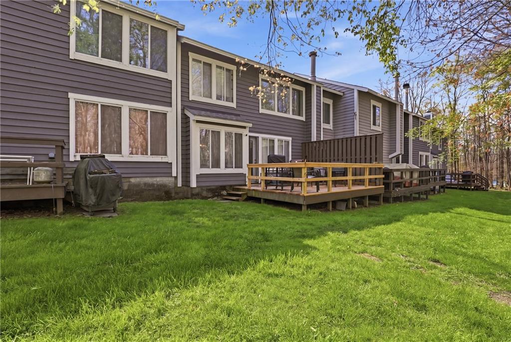 1627 Snowfield Way Hidden Valley, PA 15502 - Photo 27 of 38 a backyard of a house with wooden deck and barbeque oven
