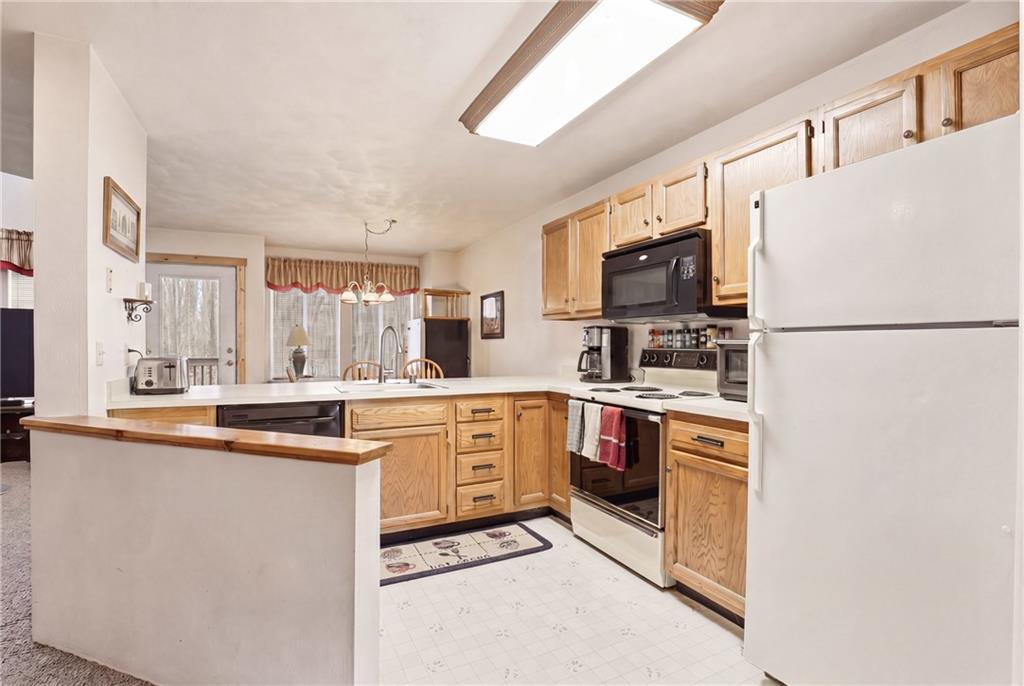 1627 Snowfield Way Hidden Valley, PA 15502 - Photo 8 of 38 a kitchen with stainless steel appliances granite countertop a stove a sink and a refrigerator