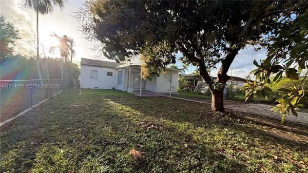 a view of a backyard with large trees
