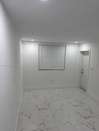 a bathroom with a shower and a sink