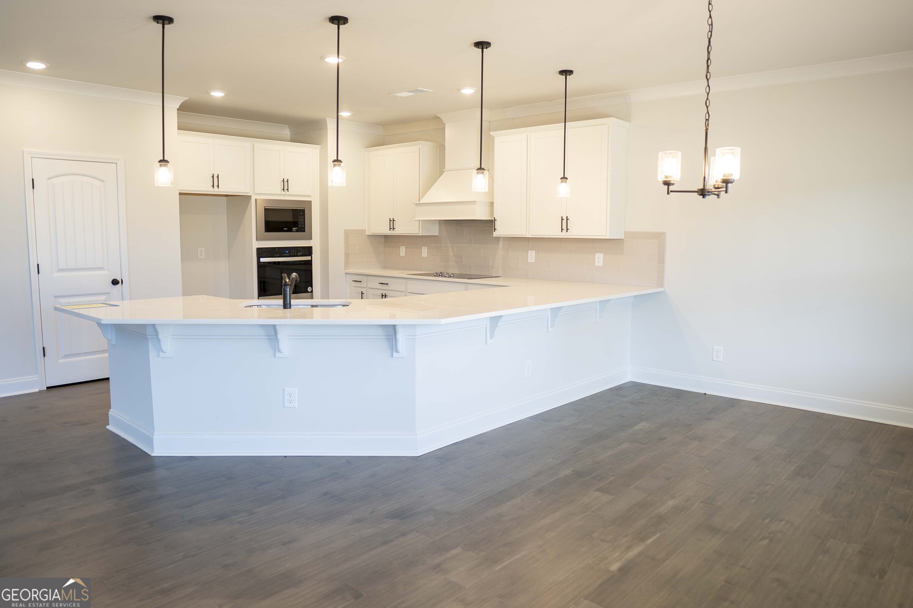 600 Beaver Court Perry, GA 31069 - Photo 15 of 48 a view of a kitchen with kitchen island a counter top space stainless steel appliances and a chandelier