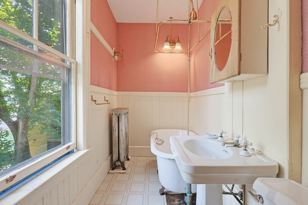 7 Baker Street Worcester, MA 01603 - Photo 38 of 42 a bathroom with a sink a toilet and mirror