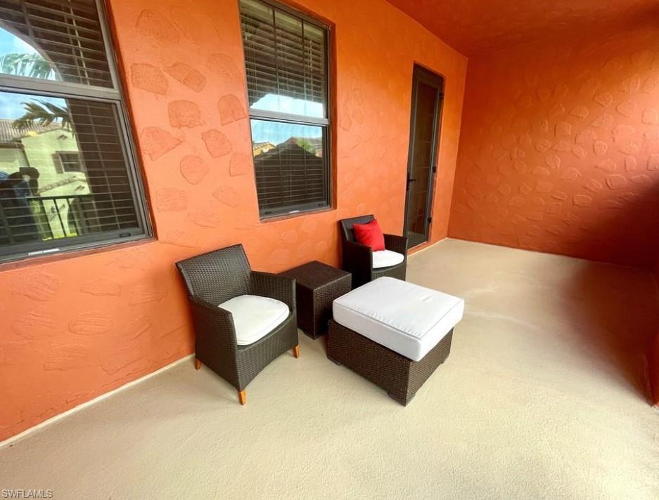 9050 Capistrano Street North, Unit 4102 Naples, FL 34113 - Photo 14 of 31 a living room with furniture and a window