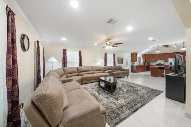 a living room with furniture kitchen view and a table