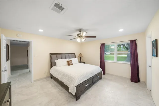 a bedroom with a large bed and a chandelier