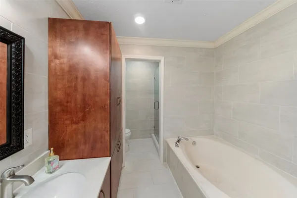 a bathroom with a tub sink and mirror