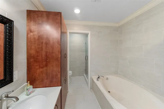 a bathroom with a tub sink and mirror