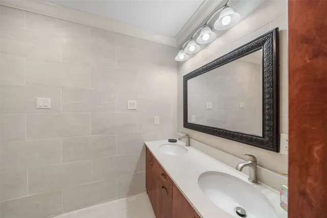 a bathroom with 2 sink and a mirror