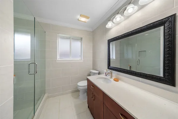a bathroom with a double vanity sink mirror and shower