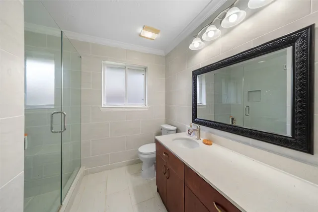 a bathroom with a double vanity sink mirror and shower