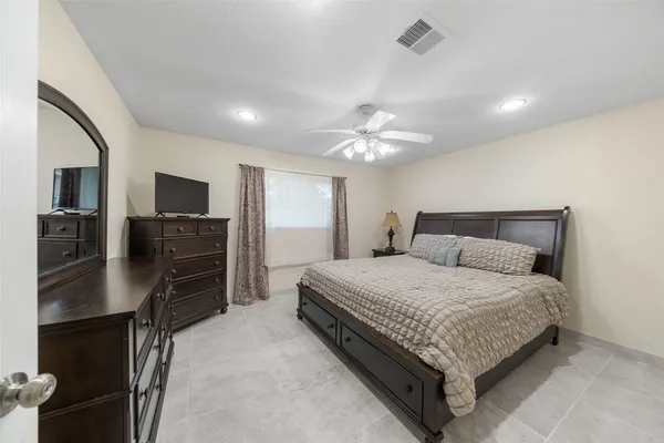 a bedroom with a bed and a television