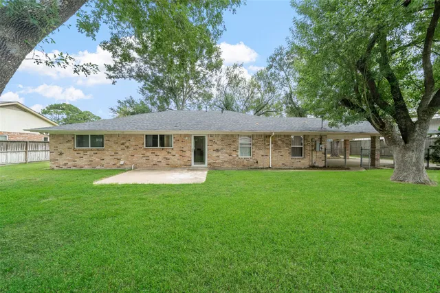 a front view of a house with yard patio and green space