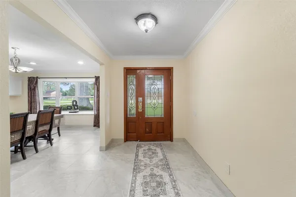 a view of a hallway with furniture and a window