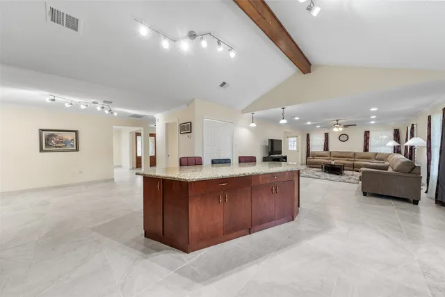 a large kitchen with a large counter top appliances and cabinets