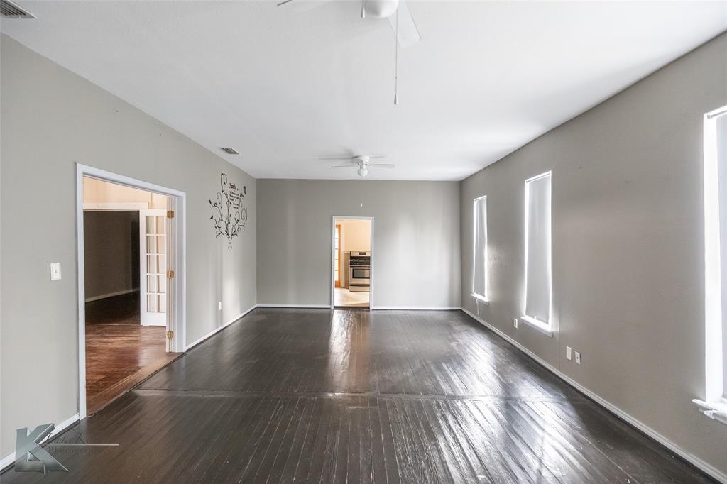 141 East 3rd Street Baird, TX 79504 - Photo 13 of 33 a view of an empty room with window and wooden floor