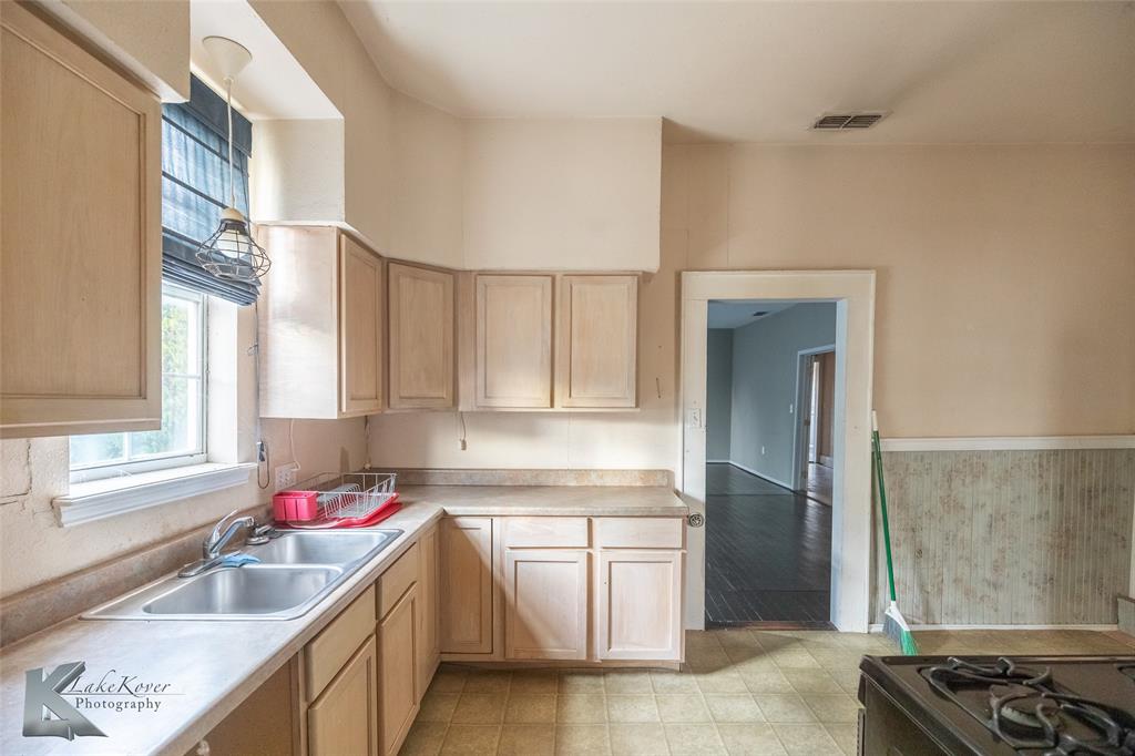 141 East 3rd Street Baird, TX 79504 - Photo 17 of 33 a kitchen with a sink cabinets and window