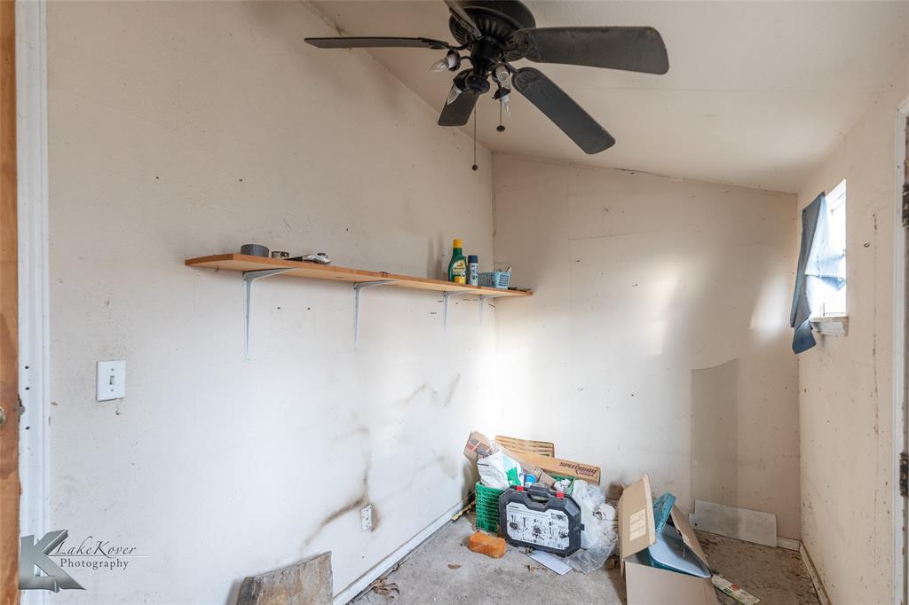 141 East 3rd Street Baird, TX 79504 - Photo 26 of 33 a view of storage and utility room with racks on the wall