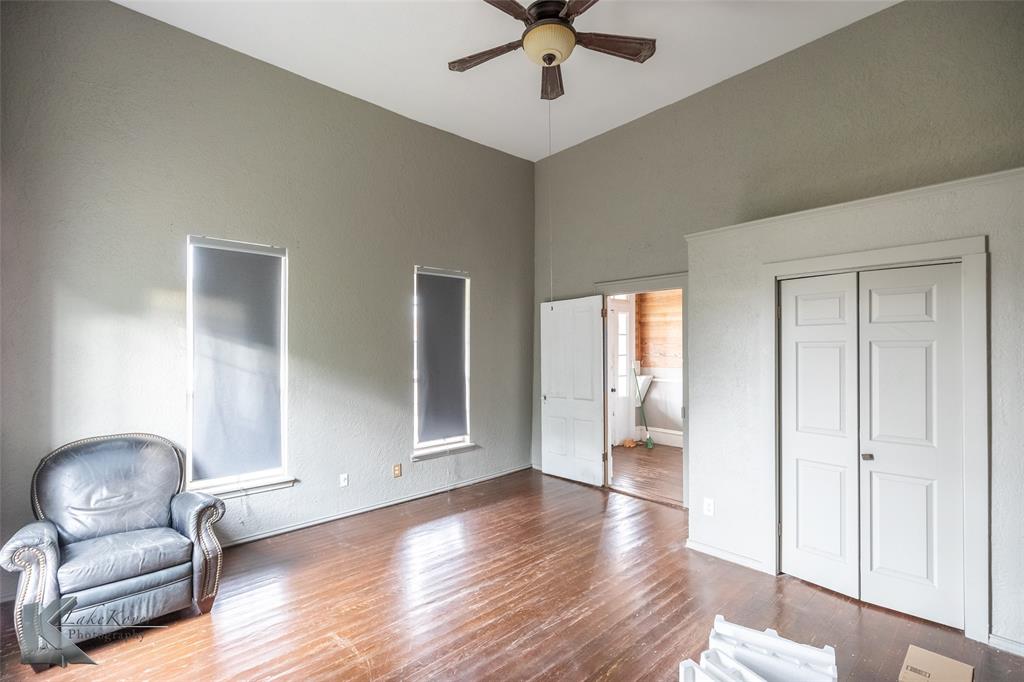 141 East 3rd Street Baird, TX 79504 - Photo 7 of 33 a view of a livingroom with furniture wooden floor and windows