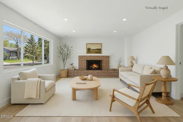 a living room with furniture and a fireplace