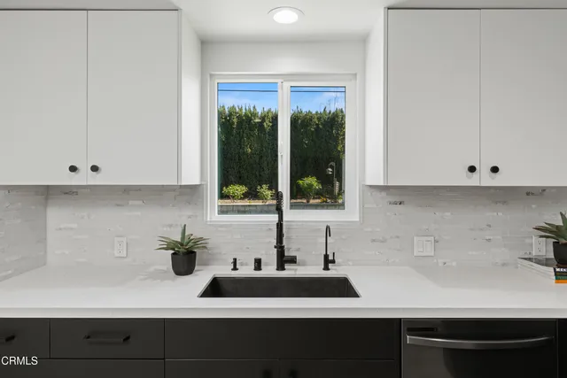 a kitchen with a sink and large window
