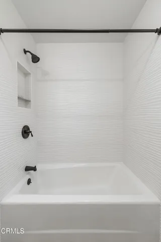 a bathroom with a shower and a bath tub